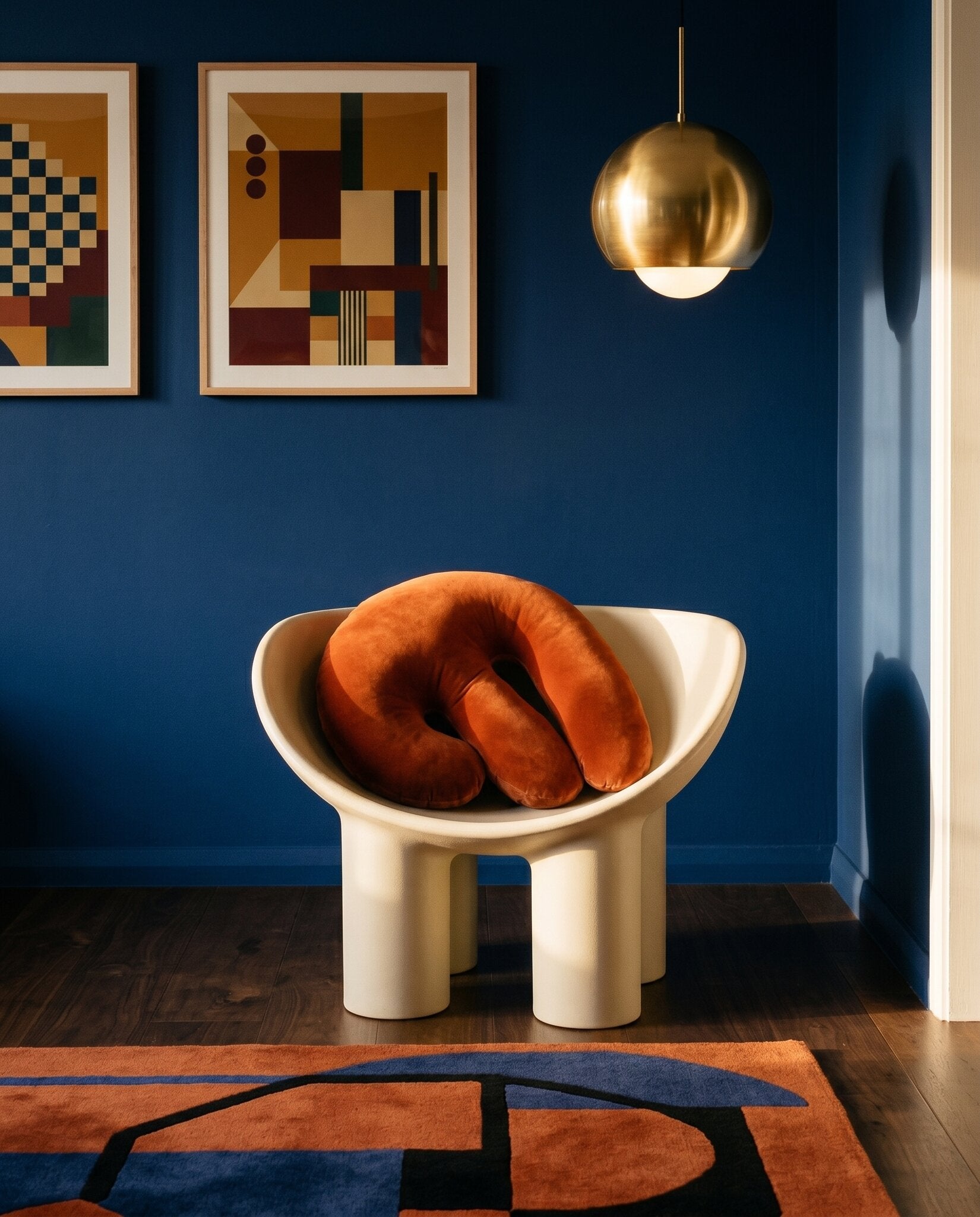Splash III Burnt Orange resting on a Faye Toogood-style sculptural cream chair in a Sydney apartment