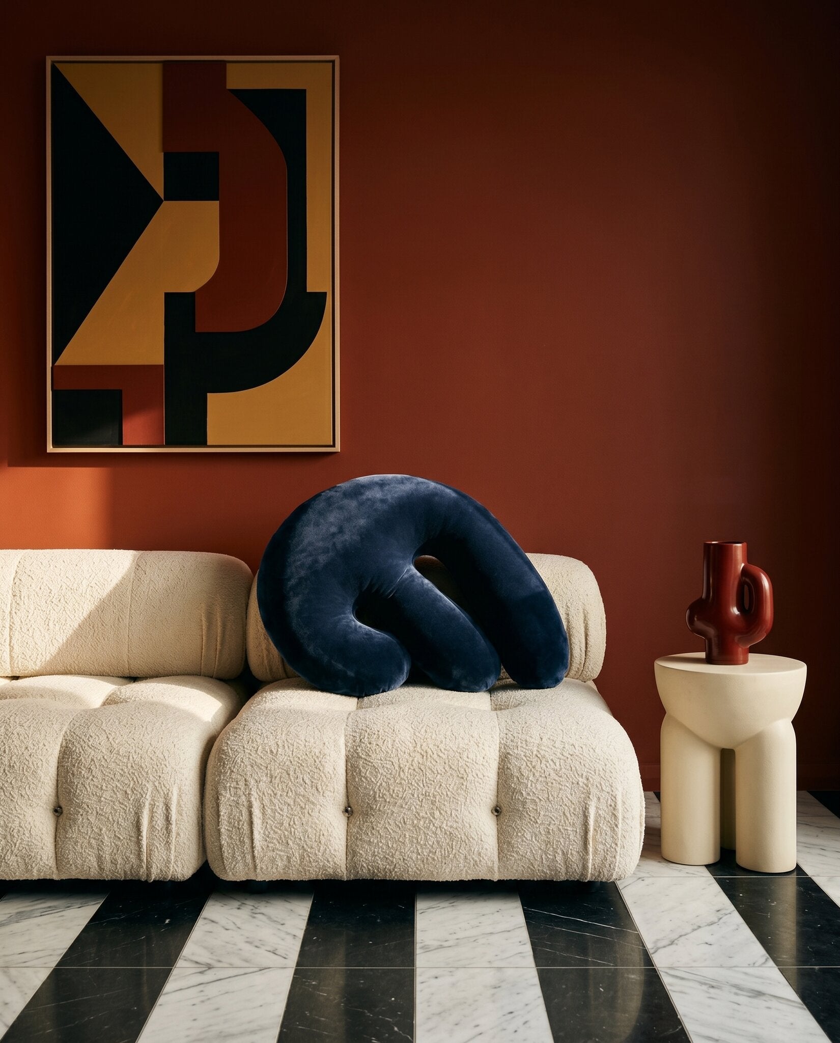 Splash III Midnight Navy on a cream Mario Bellini Camaleonda sofa in a Sydney apartment with terracotta-russet walls